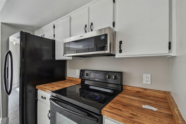 kitchen with white cabinets, wood counters, and black appliances