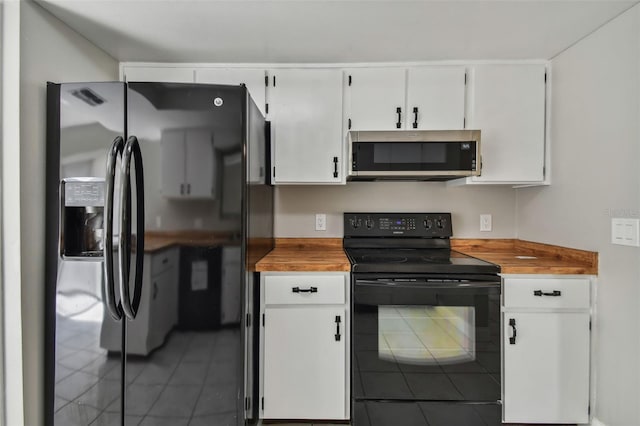 kitchen with white cabinetry, tile patterned floors, and black appliances