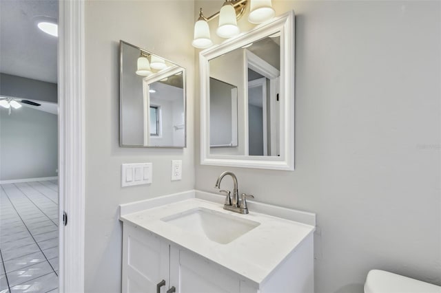 bathroom featuring vanity, ceiling fan, and toilet