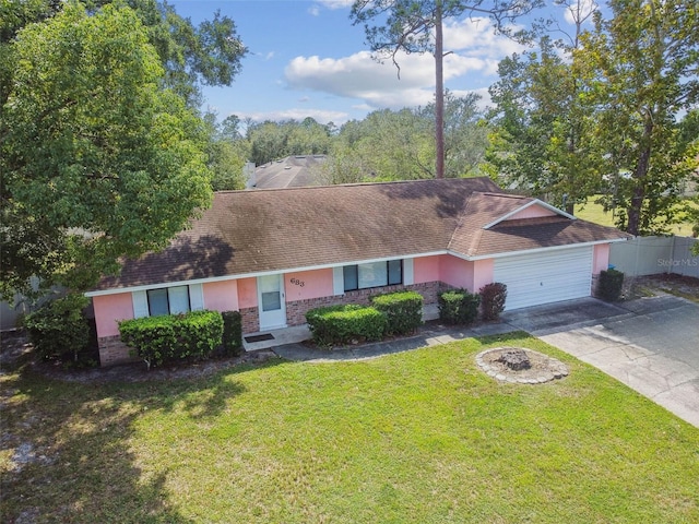 single story home featuring a garage and a front lawn