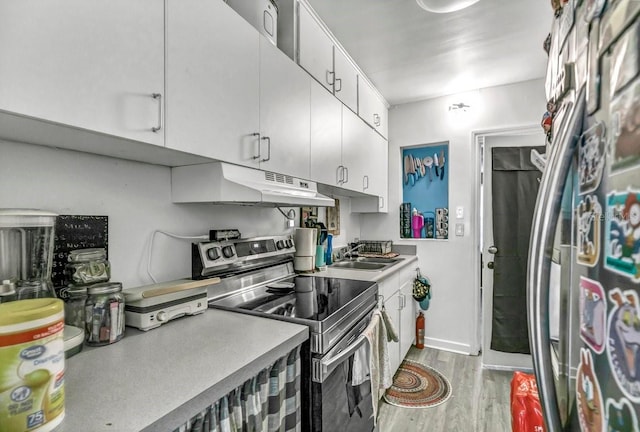 kitchen with sink, light wood-type flooring, white cabinetry, and stainless steel electric range