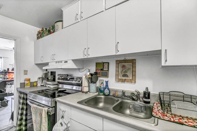 kitchen featuring white cabinets, stainless steel range with electric cooktop, and sink