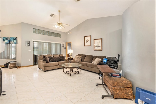 tiled living room with ceiling fan and vaulted ceiling