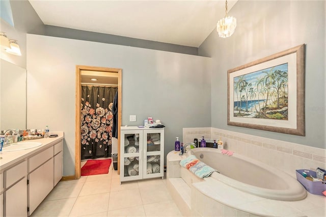 bathroom with vanity, tiled tub, tile patterned floors, and a notable chandelier