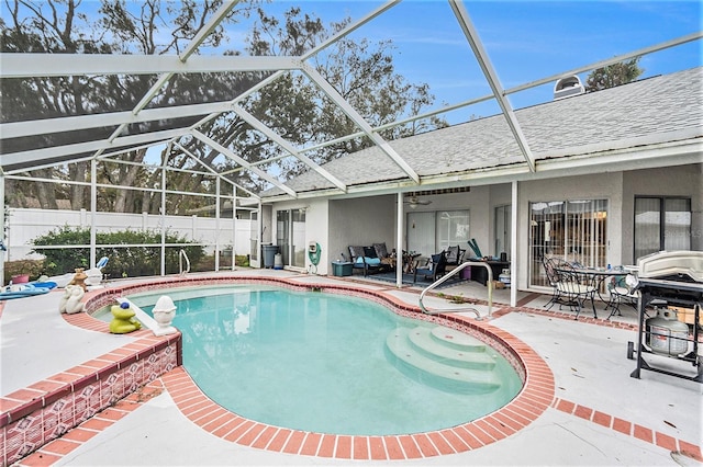 view of swimming pool featuring a lanai, a patio, and grilling area