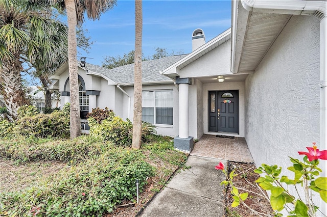 6009 County Line Rd, Spring Hill, FL 34606 - property entrance featuring a shingled roof, stucco siding, and a chimney