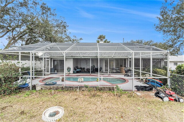 6009 County Line Rd, Spring Hill, FL 34606 - back of property featuring fence, a fenced in pool, a patio area, glass enclosure, and a yard