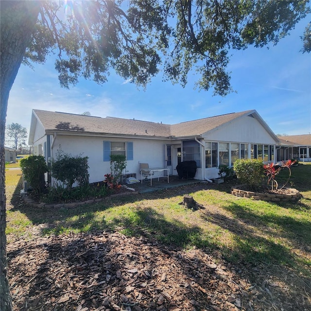 rear view of property with a lawn