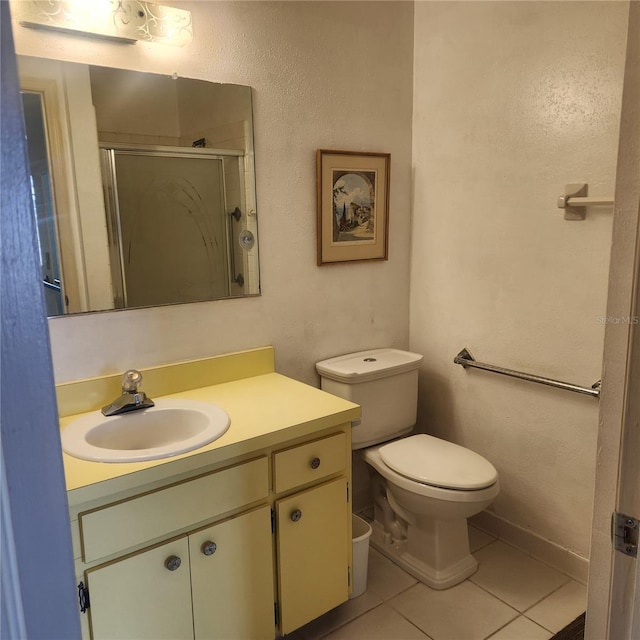 full bathroom with tile patterned flooring, toilet, a shower stall, and vanity