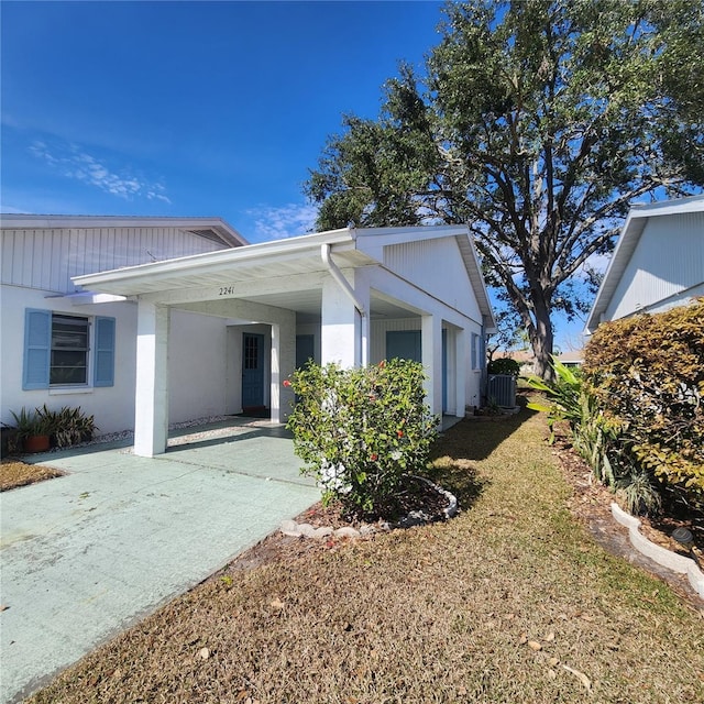 exterior space with concrete driveway and an attached carport