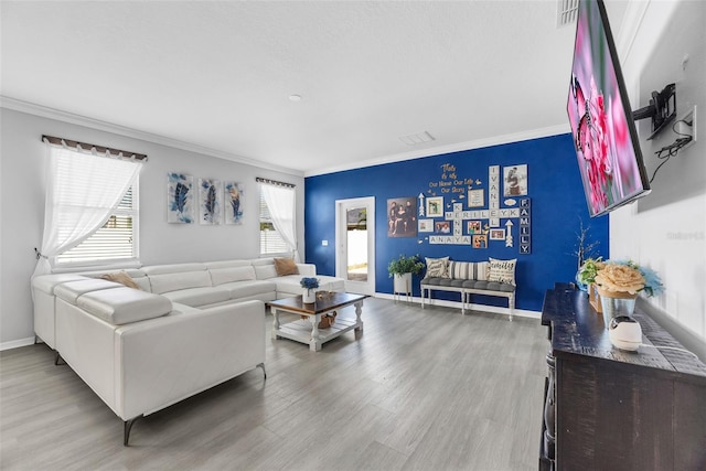 living room with crown molding and wood-type flooring