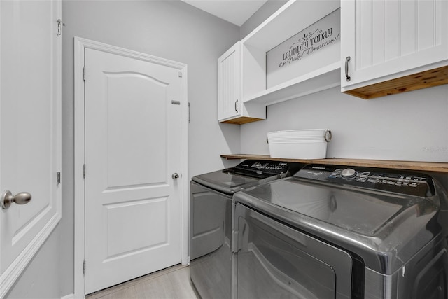 laundry area with cabinets and independent washer and dryer