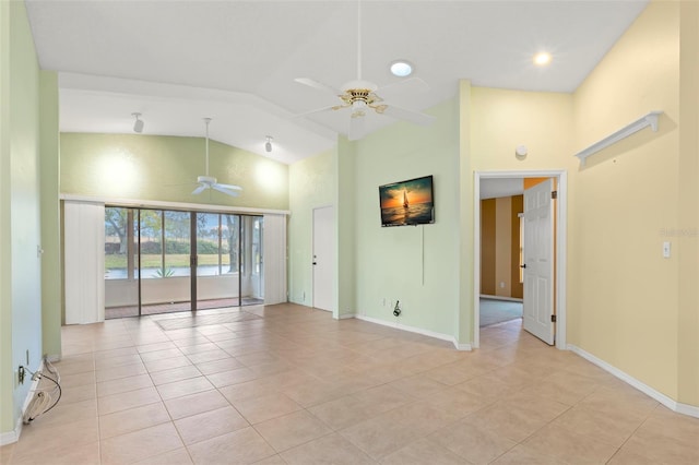 empty room featuring vaulted ceiling, ceiling fan, and light tile patterned floors