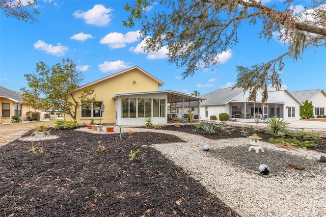 rear view of house featuring a sunroom