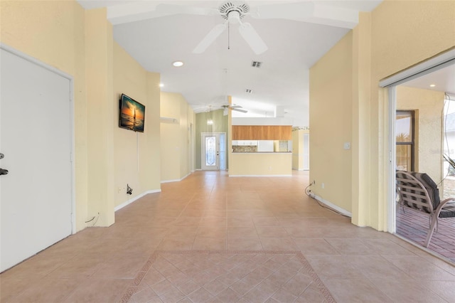 hallway with vaulted ceiling and light tile patterned floors