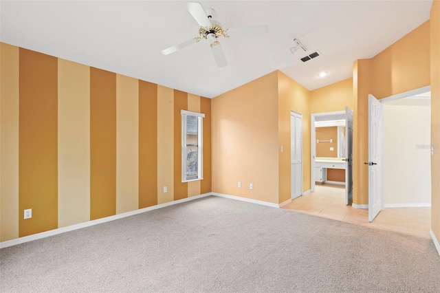 carpeted empty room featuring ceiling fan