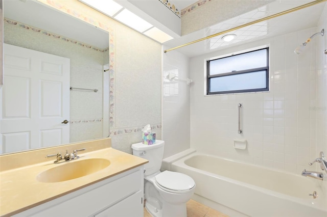 full bathroom featuring toilet, tiled shower / bath, tile patterned flooring, and vanity