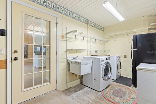 washroom with sink and separate washer and dryer