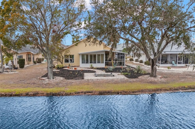 rear view of house with a sunroom