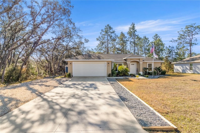 single story home with a garage and a front lawn