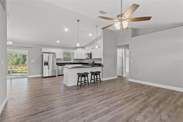 kitchen with white cabinets, light wood-type flooring, plenty of natural light, and appliances with stainless steel finishes