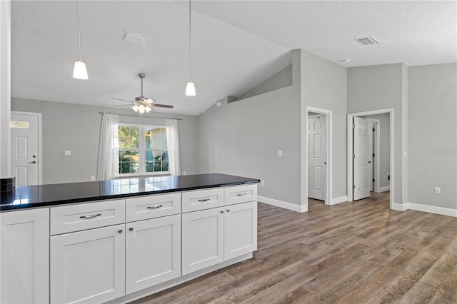 kitchen with white cabinetry, hanging light fixtures, light wood-type flooring, ceiling fan, and lofted ceiling