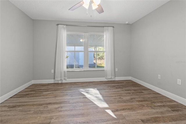 unfurnished room with hardwood / wood-style flooring and ceiling fan