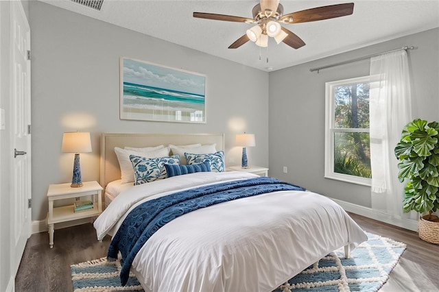 bedroom with wood-type flooring, a textured ceiling, and ceiling fan