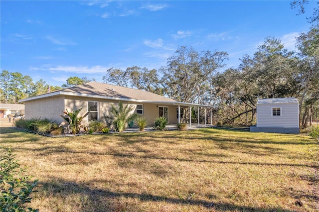 rear view of property featuring a storage shed and a lawn