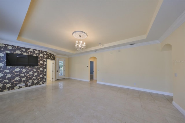 unfurnished living room featuring crown molding, an inviting chandelier, and a raised ceiling