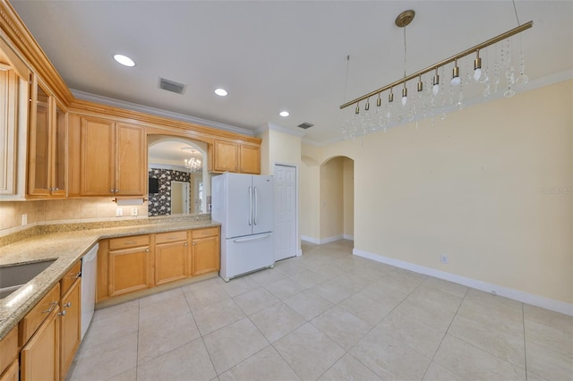 kitchen with tasteful backsplash, light tile patterned floors, light stone countertops, white appliances, and ornamental molding