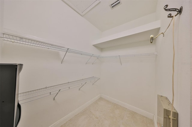 spacious closet with tile patterned floors