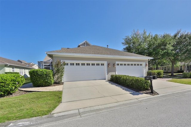 view of front of house with a front yard and a garage