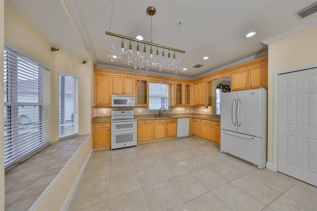 kitchen with visible vents, a sink, white appliances, crown molding, and glass insert cabinets