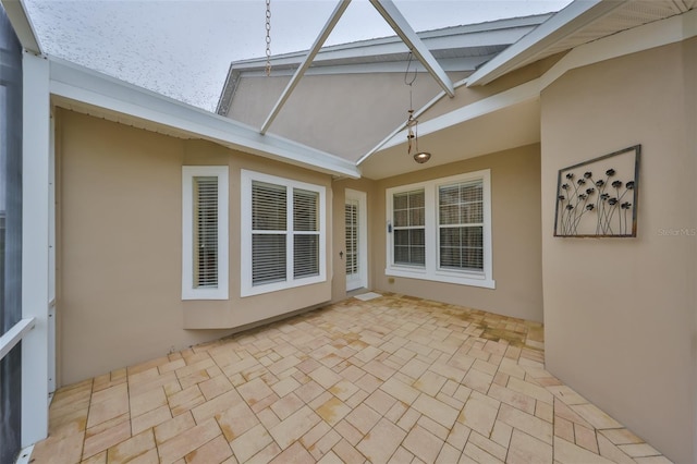 view of side of home with a patio area and stucco siding