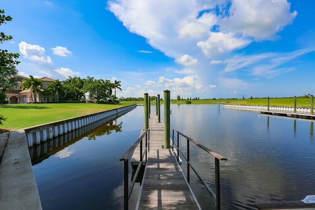 dock area with a yard and a water view