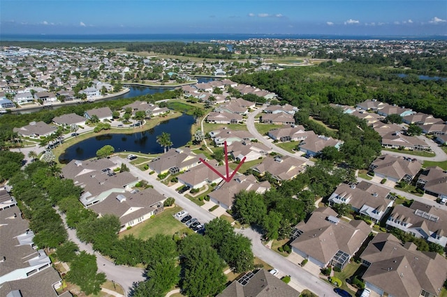 birds eye view of property with a residential view and a water view