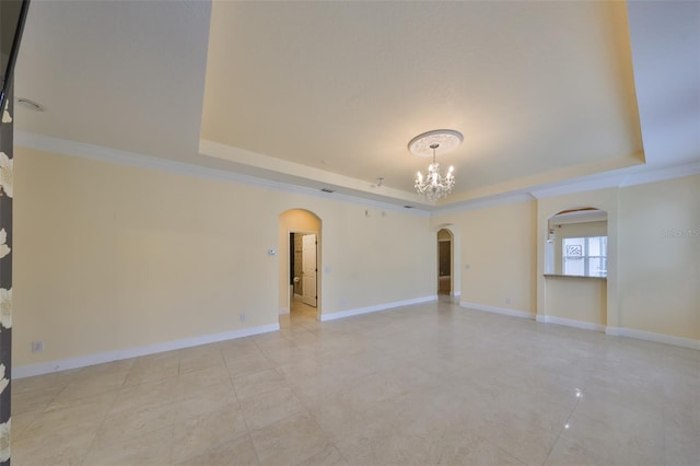 empty room with an inviting chandelier, a raised ceiling, arched walkways, light tile patterned flooring, and baseboards