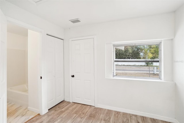 unfurnished bedroom featuring light wood-type flooring