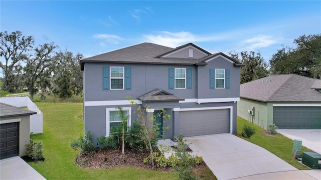 view of property with a garage and a front yard