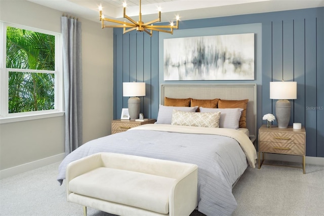 carpeted bedroom featuring an inviting chandelier