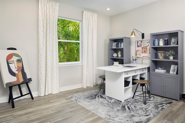 office with light wood-type flooring