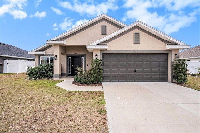 view of front of home featuring a garage and a front yard