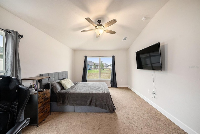 bedroom with ceiling fan, light colored carpet, and lofted ceiling