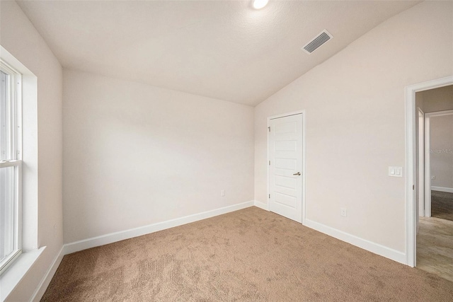 unfurnished bedroom with carpet floors and lofted ceiling