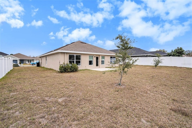 back of property with a patio area and a lawn