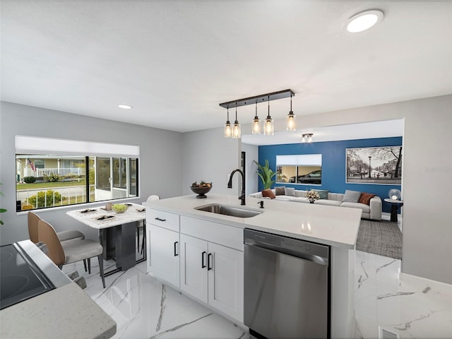 kitchen featuring dishwasher, decorative light fixtures, white cabinetry, sink, and a kitchen island with sink