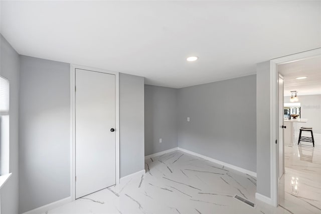 unfurnished bedroom featuring marble finish floor, recessed lighting, a closet, visible vents, and baseboards