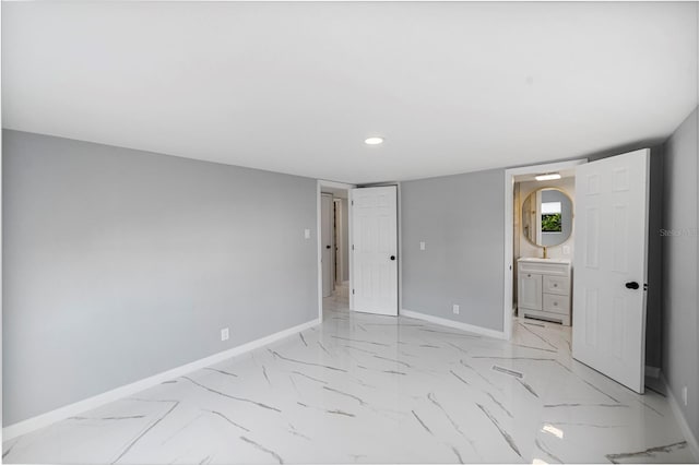 unfurnished bedroom with marble finish floor, recessed lighting, connected bathroom, and baseboards