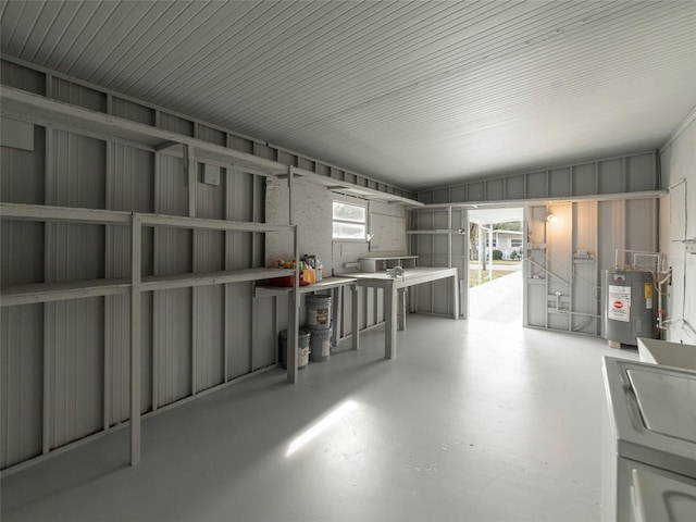 garage with metal wall and electric water heater